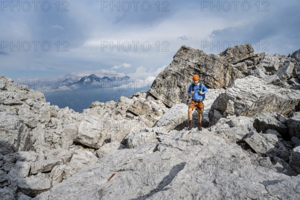 Mountaineers between large boulders, rocky mountain landscape, Via Ferrata SOSAT via Ferrata, in