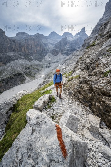 Mountaineers on a hiking trail with red trail markings, rocky mountain landscape, Via Ferrata SOSAT