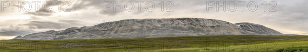 A massive granite rock mountain with bare fells dominates the landscape of the central Varanger