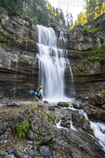 Young woman in front of Cascata di Mezzo waterfall, long exposure, Vallesinella, Brenta, Trentino,