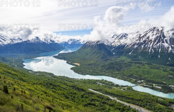 View of snowy mountains in spring and turquoise blue Kenai Lake, Slaughter Ridge Trail, Cooper