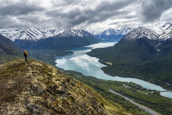 Climbers on a hiking trail on Slaughter Ridge, views of snowy mountains in spring and turquoise