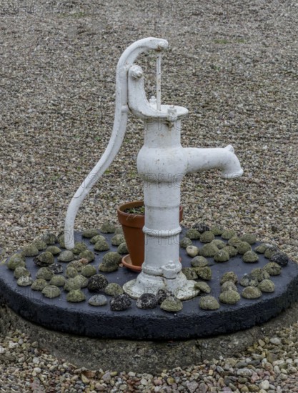 Classic hand pump for water as a decoration in a courtyard in Ystad municipality, Skåne county,
