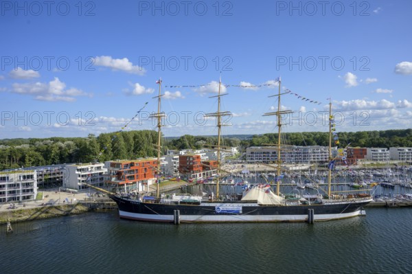Harbour view with the legendary four-masted PASSAT barque and many boats in front of modern