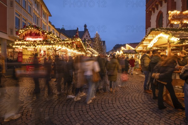 December 22, 2025, Frankfurt Christmas Market on Roemerberg at twilight. Traditional wooden stalls