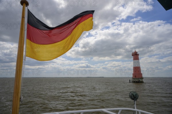 German flag and Angaster lighthouse in Jade Bay taken from an excursion ship, Jade Bay, Lower