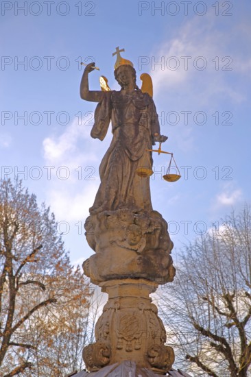Justice as an angel and golden crown with cross, and beam scale, golden wings, symbol of justice