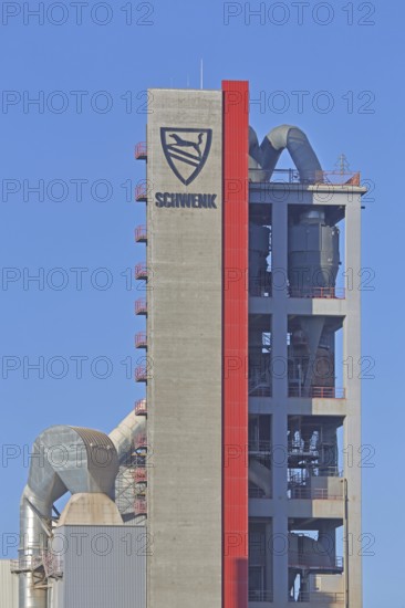 Silo with inscription and emblem of Zementfabrik Schwenk Manufacture of cement, tower with pipes,