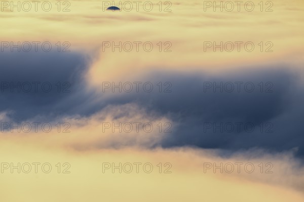 View from Mount Domen. Thick sea fog hangs over the Barents Sea and the midnight sun shines in an