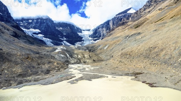 Sun shining over the athabasca glacier in jasper national park, alberta, canada, with meltwater
