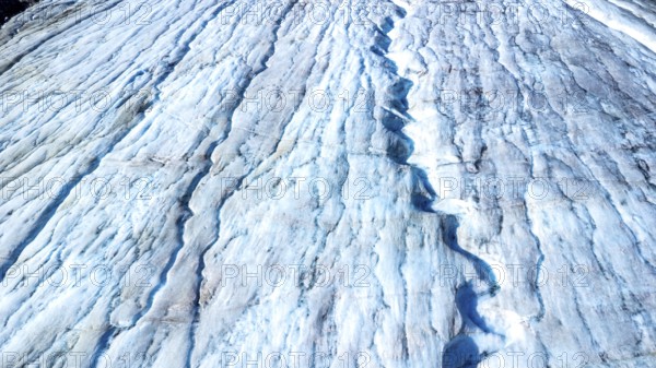 Melting glacial ice flowing down the athabasca glacier reveals stunning blue crevasses,
