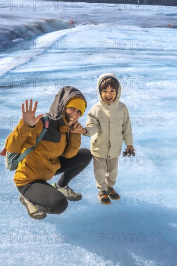 Mother and her son are enjoying their visit to the athabasca glacier in jasper national park,