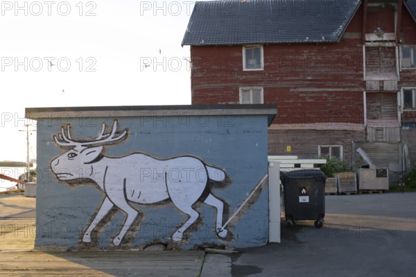 Mural depicting a reindeer at the harbor. Vardö street art phenomenon created by the festival