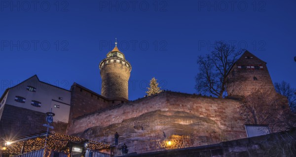 Illuminated Sinwell Tower, built in the 13th century, in the evening sky, Kaiserburg, Nuremberg,