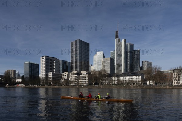 A rowing boat passes on the Main in front of Frankfurt's banking skyline, Mainufer, Frankfurt am