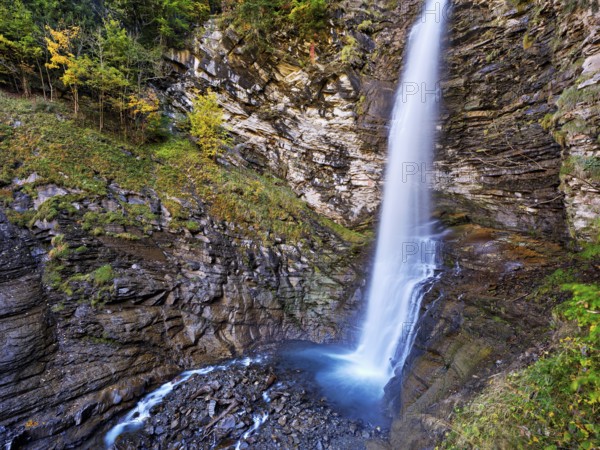 Diesbach waterfall in autumn-colored surroundings, Linthal, Klausenpass, Canton of Glarus,
