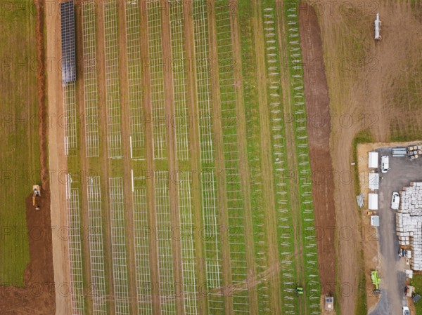 Aerial view of a construction project for solar energy with a cross-field framework, Energiewende,