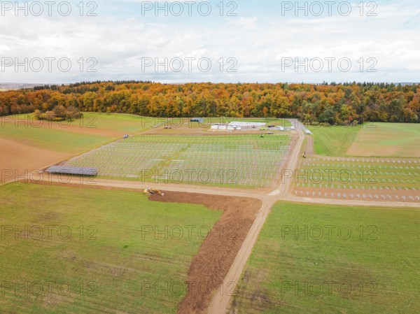 Wide landscape with fields and construction areas for solar systems near forest, energy transition,