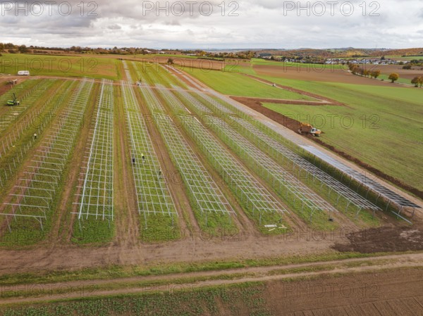 Aerial view of a solar plant under construction on extensive fields, energy transition,