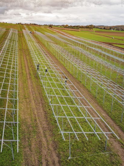 Structures of an incipient solar plant in fields in a rural area, energy transition, construction