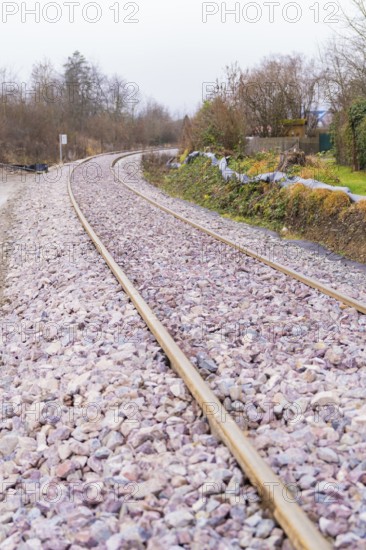 Close-up of a winding railway line with rails and gravel, construction of the Hermann Hesse