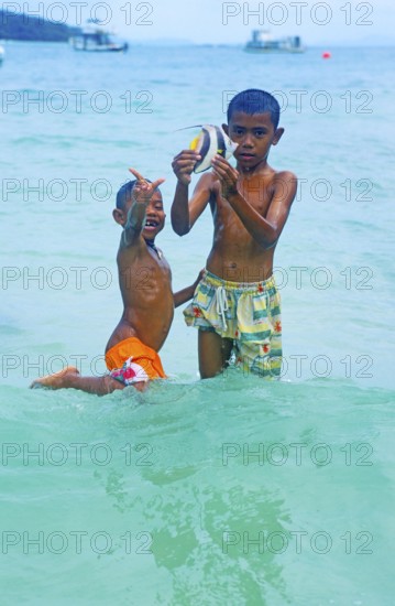 Two boys with a tropical fish on Ko Phi Phi Don, two years in front of the tsunami, Thailand,