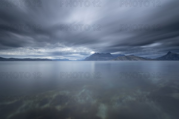 The Vestfjord in Nordland, Norway, near Bodø, impresses with a dramatic atmosphere. Dark clouds