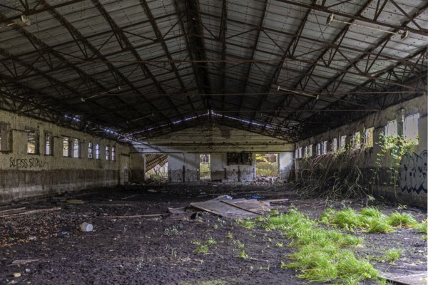 Abandoned hall with Grafity, dilapidated plant of a former agricultural production cooperative of