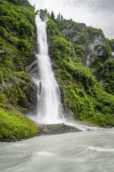 Horsetail Falls waterfall on the Lowe River in a green gorge, long exposure, Keystone Canyon,