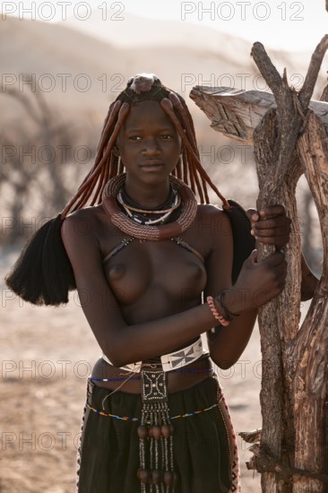 Young Himba woman with jewelry, portrait, traditional Himba village, Kaokoveld, Kunene, Namibia