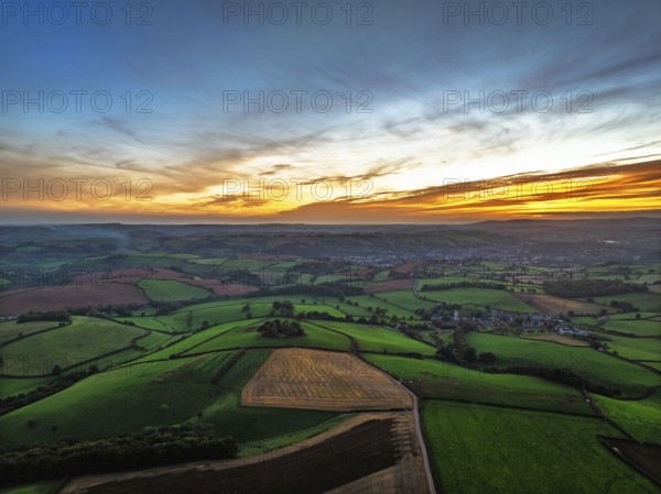 Sunset of Devon Farms and Fields over Berry Pomeroy from a drone, Totnes, England, United Kingdom