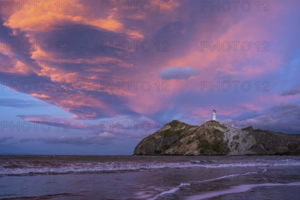 Castlepoint Beach, ocean and lighthouse on a rock, evening, sunset, dramatic sky. Castlepoint,