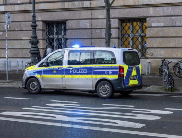 Police vehicles with flashing lights switched on, special operation at the Berlin State Library,
