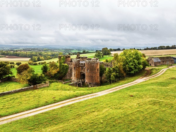 Autumn Colours over ruins of Pembridge Castle or Newland Castle from a drone, Herefordshire,