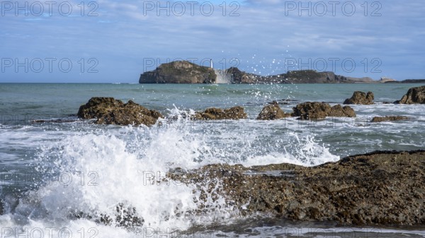 Castlepoint Beach and Castlepoint Lighthouse, ocean, waves, surf, sandy beach, rocks. Castlepoint,