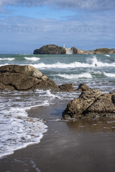 Castlepoint Beach and Castlepoint Lighthouse, ocean, waves, surf, sandy beach, rocks. Castlepoint,