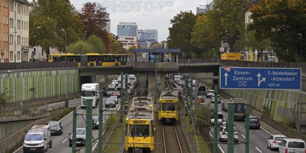 Lots of traffic on the A 40 motorway on four lanes and two subways on two lanes and a bus on the