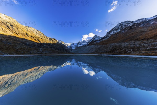 The Moiry glacier and mountain peaks are reflected in Lac de Chateaupre, Val d'Anniviers, Valais