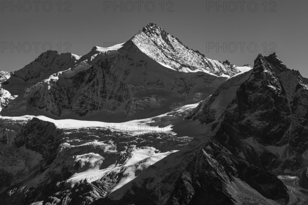 The snow-capped peaks of the Zinalrothorn and Besso mountains, black and white photo, Val