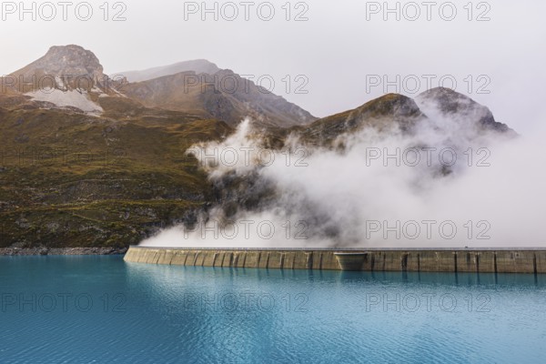 Fog rises over the dam of the Lac de Moiry Reservoir, Val d'Anniviers, Valais Alps, Canton of