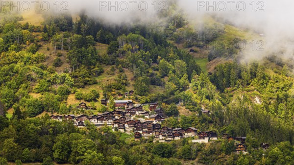 Fog over the mountain village of Pinsec, Val d'Anniviers, Valais Alps, Canton of Valais,