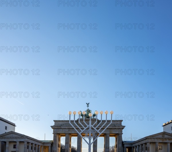 Large Hanukkah chandelier at the Brandenburg Gate in daylight, sign of lively Jewish life, symbolic