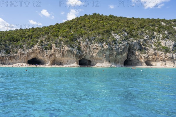 Clear blue water and picturesque rocky coast, Cala Luna cliffs and beach, Golfo di Orosei, Baunei,
