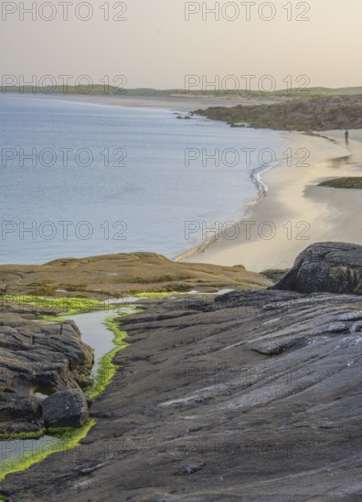 Granite rocks in the evening light and turquoise blue sea at Gurteen Beach, Roundstone, County