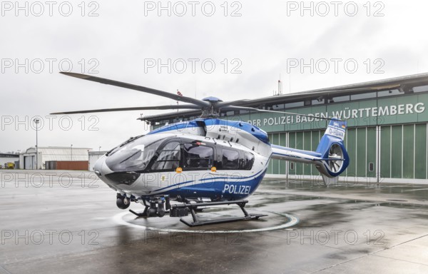 Helicopter from the Baden-Württemberg Police team in front of the hangar at the airport. Airbus