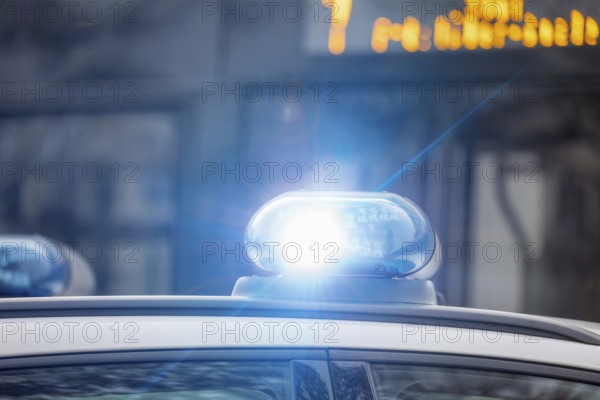 Symbolic image police operation: close-up of a blue light on a police car (digitally reworked)