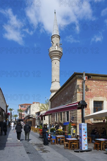 Street view with minaret and cafes under a clear blue sky, Yali Mosque, Tavil Ahmet Aga Mosque,