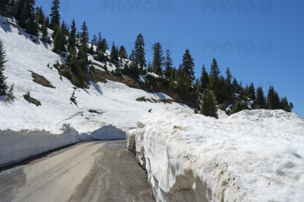 A mountain road lined with high snow walls offers an impressive winter landscape, near Goderdzi on