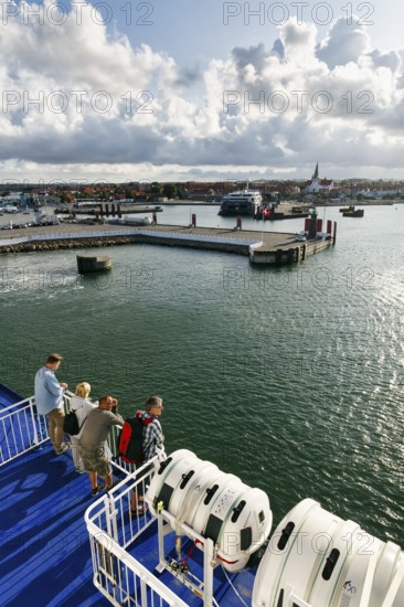 Tourists on the ferry to Rügen, ferry terminal, harbor with cityscape, St. Nicholas Church,