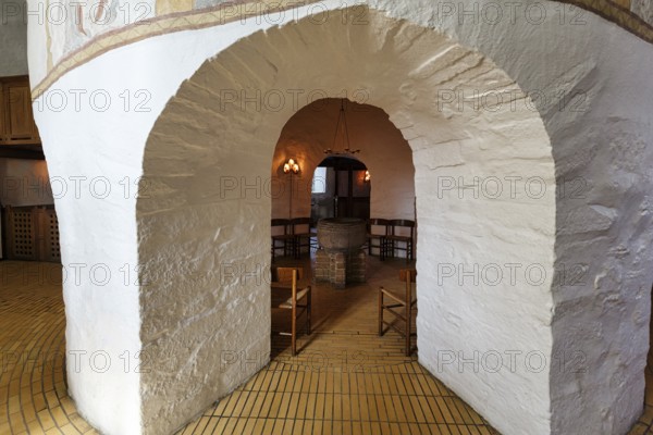 Medieval round church, baptistery with baptismal font, distinctive stone arches, interior,